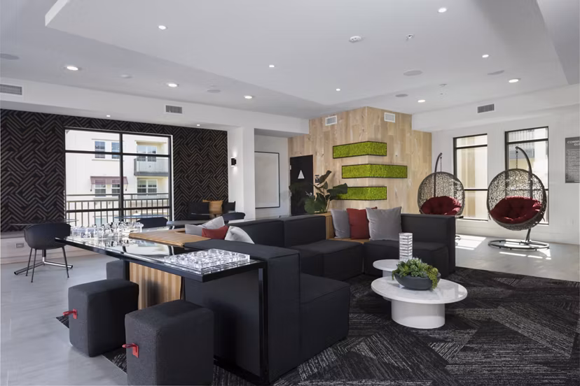 Revela Apartments: Modern game room featuring pool table and arcade games, perfect for entertainment and relaxation