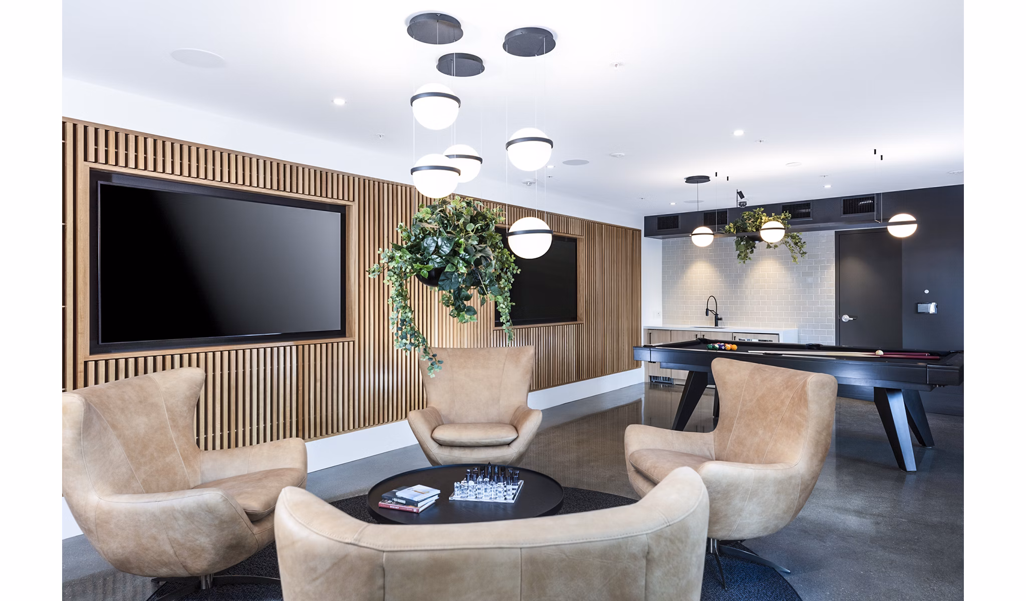 Game room with billiards table at Revela Apartments offering a luxury lifestyle in an amenity-rich community for residents