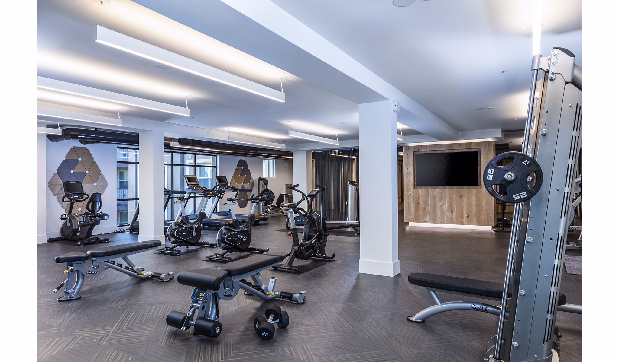 Modern fitness center with state-of-the-art equipment at Revela Apartments in a luxury setting