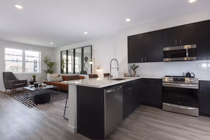 Modern kitchen with stainless steel appliances at Revela Apartments