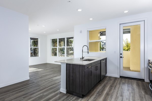 Modern kitchen with stainless steel appliances at Revela Apartments