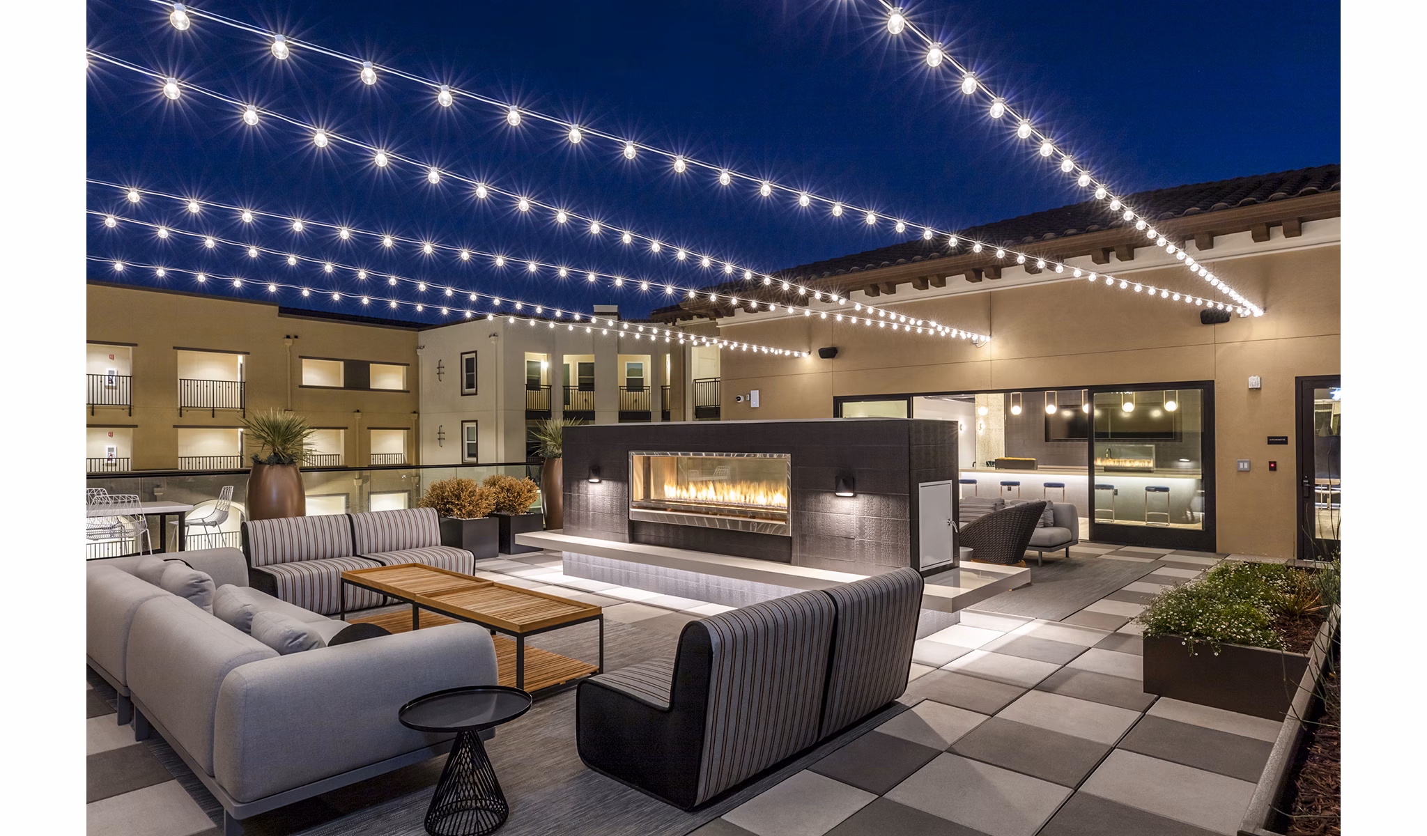 Spacious balcony with cozy fireplace at Revela Apartments, perfect for luxury outdoor living