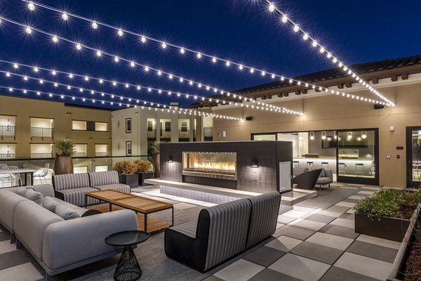 Spacious balcony with cozy fireplace at Revela Apartments, perfect for luxury outdoor living