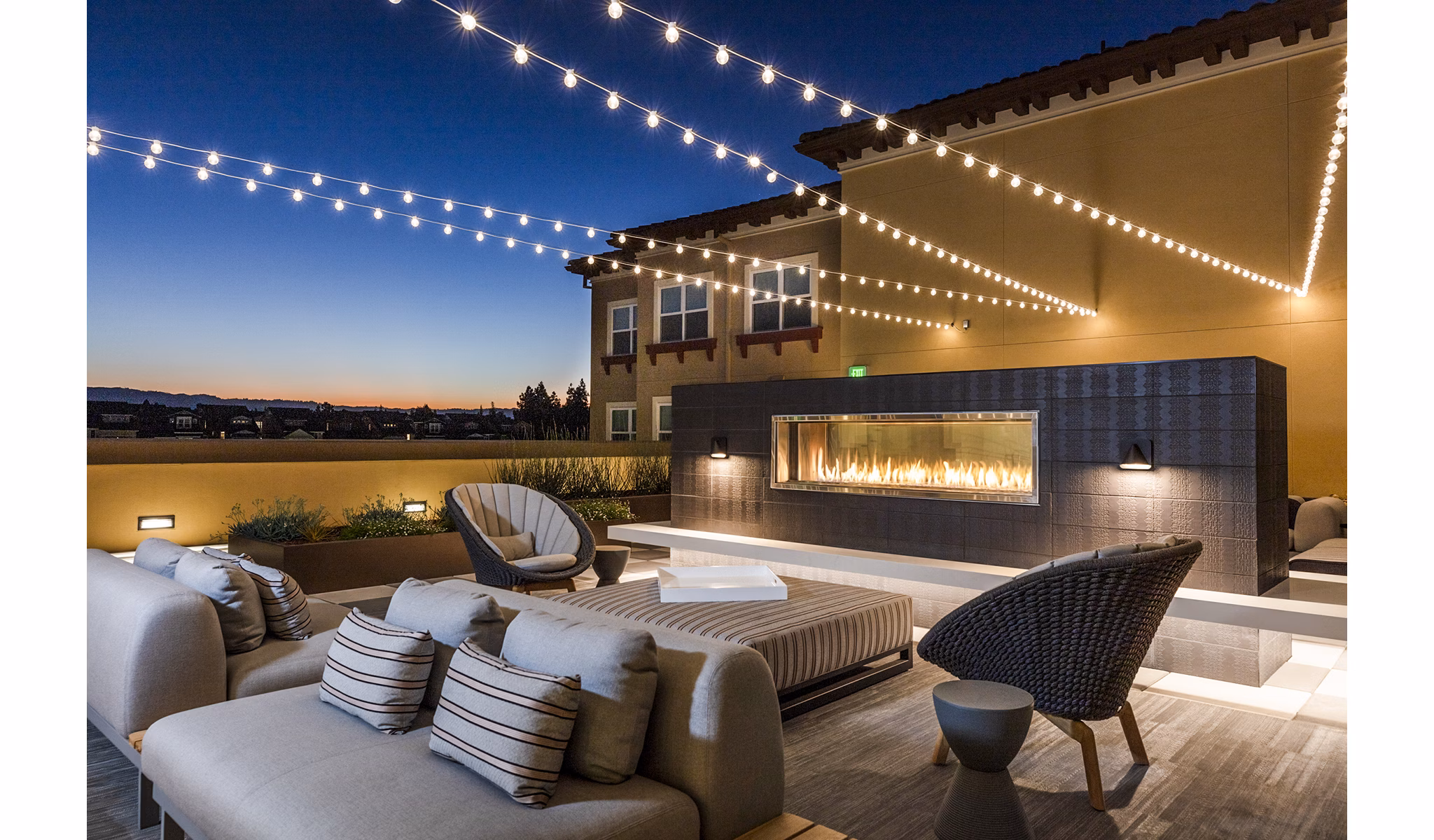 Cozy patio with fireplace at Revela Apartments, ideal for relaxation and gatherings, showcasing luxury living in a vibrant community setting