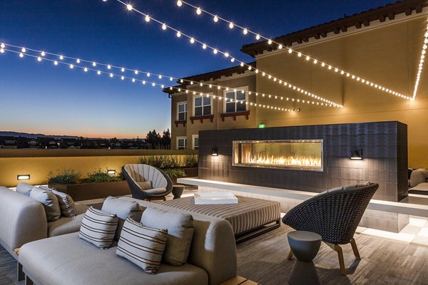 Cozy patio with fireplace at Revela Apartments, ideal for relaxation and gatherings, showcasing luxury living in a vibrant community setting