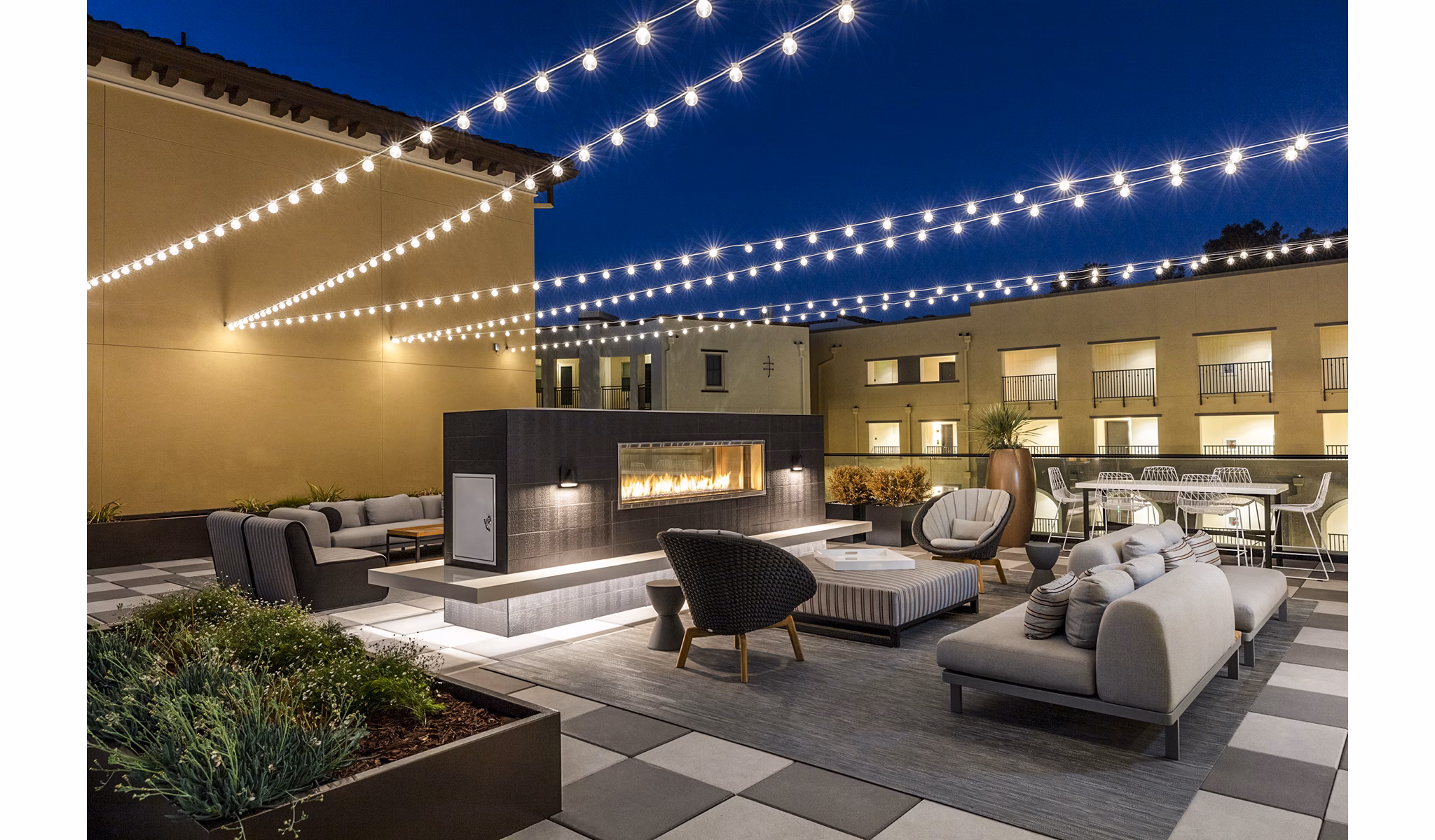 Cozy outdoor patio with fireplace at Revela Apartments