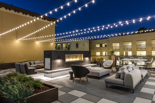 Cozy outdoor patio with fireplace at Revela Apartments