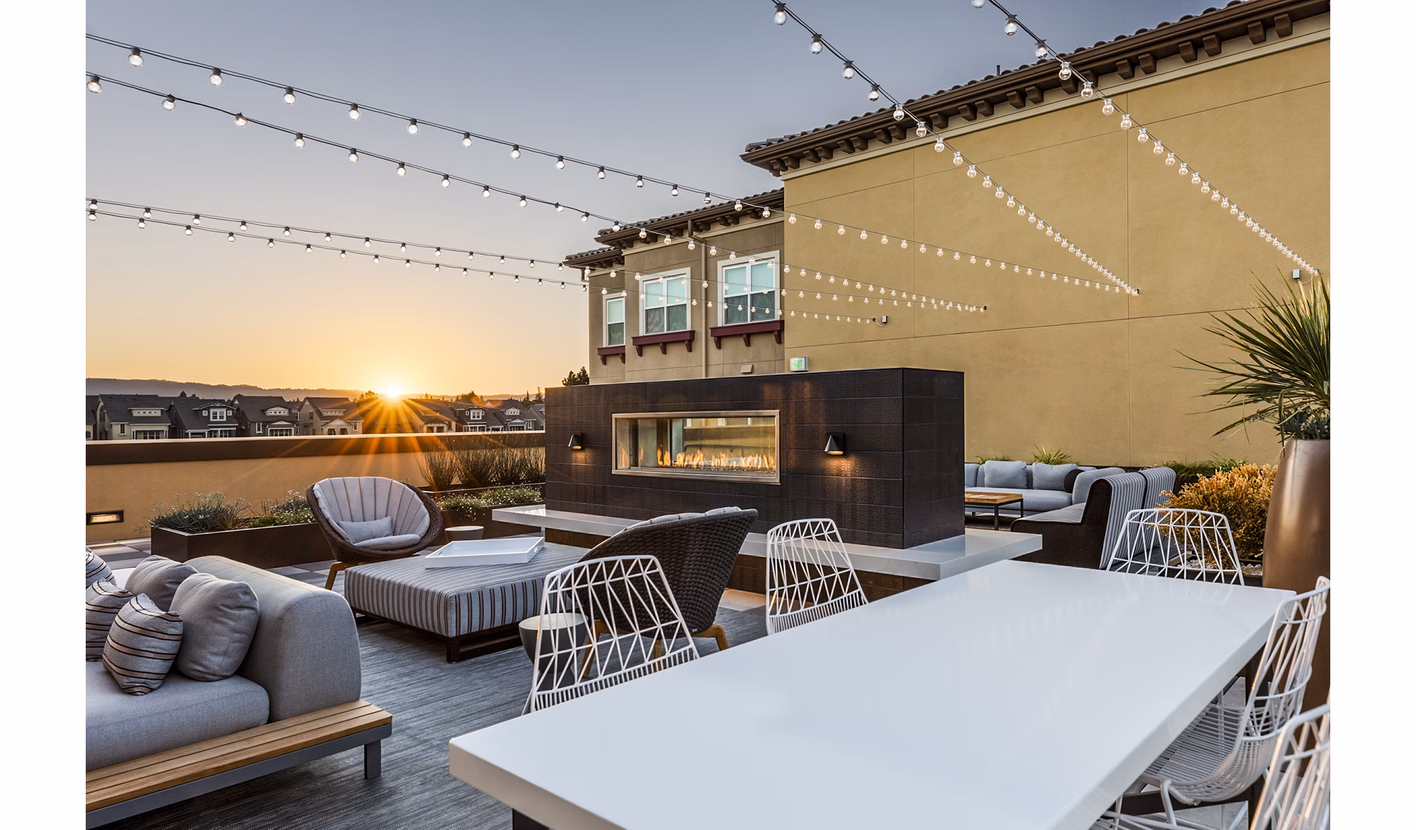 Patio featuring a cozy fireplace at Revela Apartments, luxury living with outdoor amenities