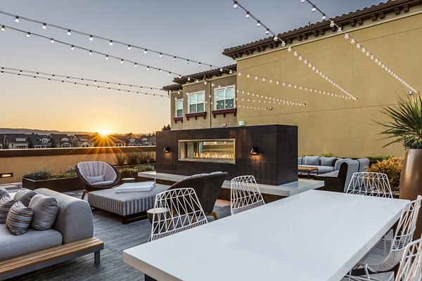 Patio featuring a cozy fireplace at Revela Apartments, luxury living with outdoor amenities