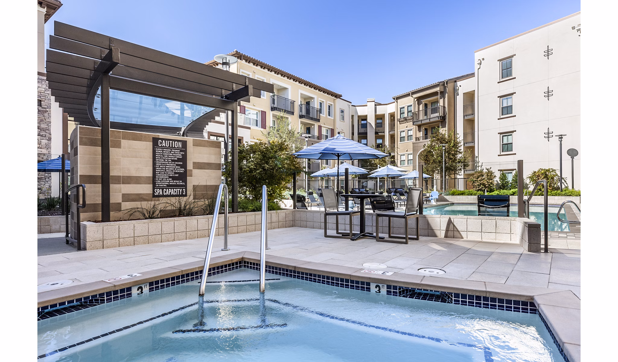Insulated with a landscaped setting, the resort-style pool at Revela Apartments offers luxury relaxation