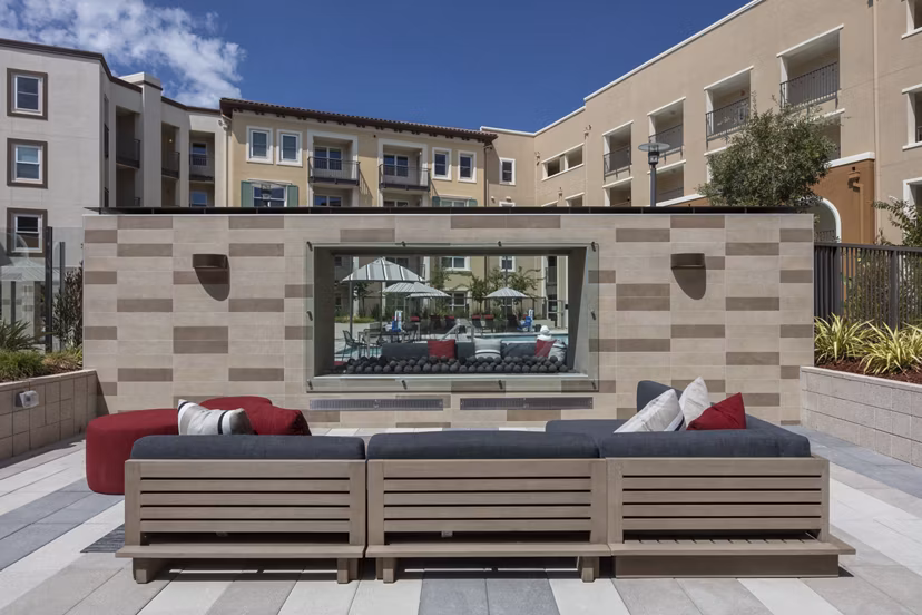 Modern grill area with seating at Revela Apartments, perfect for outdoor gatherings and BBQs in a luxury setting