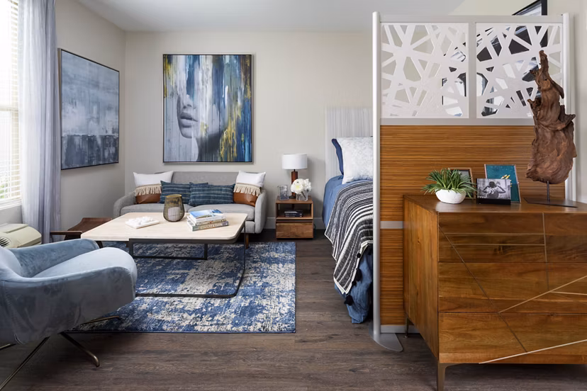 Open-concept kitchen with stainless steel appliances and granite countertops at Entrada Apartments