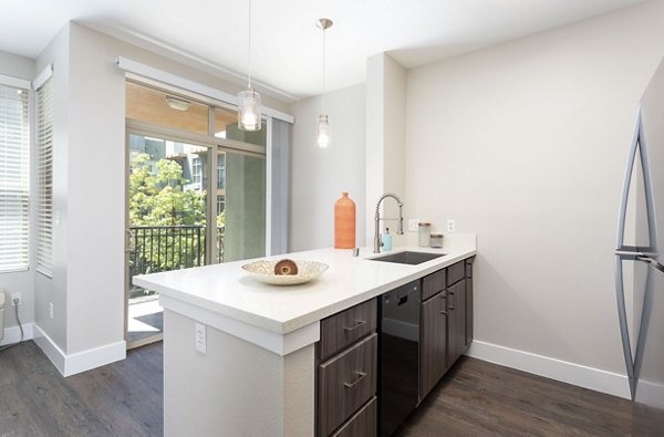 Entrada Apartments: Modern kitchen featuring stainless steel appliances and granite countertops