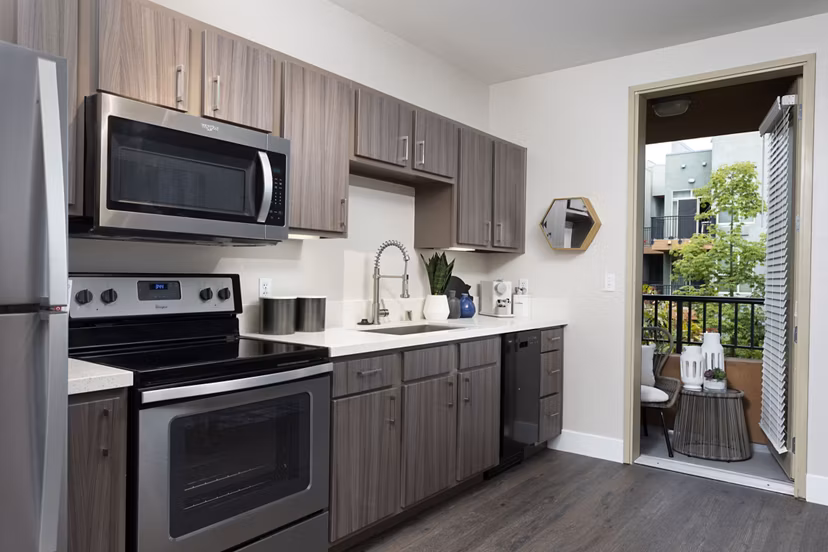 Entrada Apartments: Modern kitchen with stainless steel appliances and granite countertops