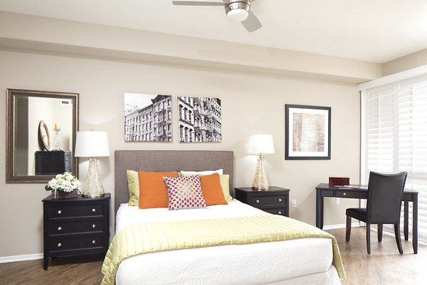 Bedroom with modern decor and large windows at Regents La Jolla Apartments