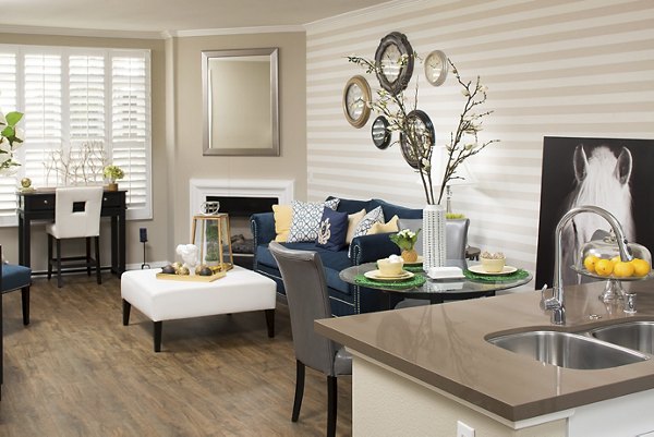 Living room with modern decor and large windows at Regents La Jolla Apartments