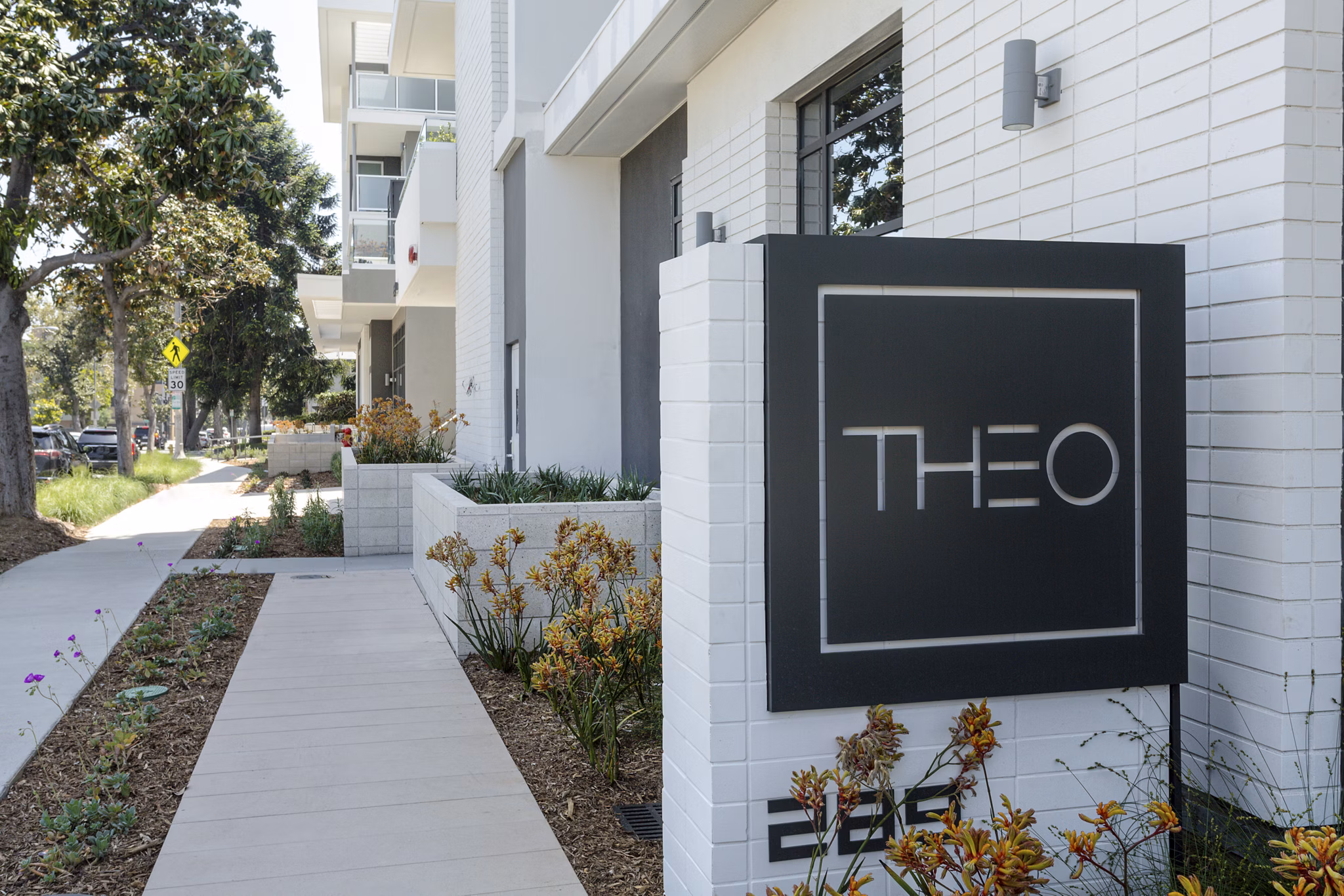 THEO: Signage at luxury apartment community highlighting modern design elements in San Diego