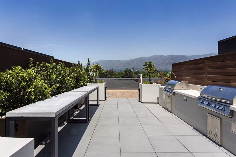 Grill area with modern seating and BBQ stations at THEO luxury apartments