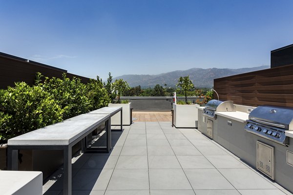 Grill area with modern seating and BBQ stations at THEO luxury apartments