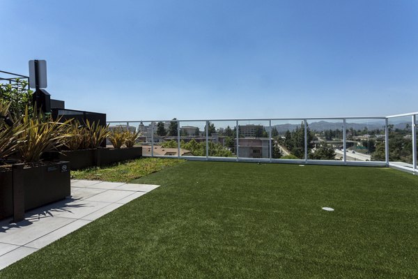 Putting green at THEO offering scenic golfing views in a luxury apartment setting