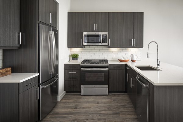 Modern kitchen with sleek appliances in Broadstone Sawyer Yards Apartments