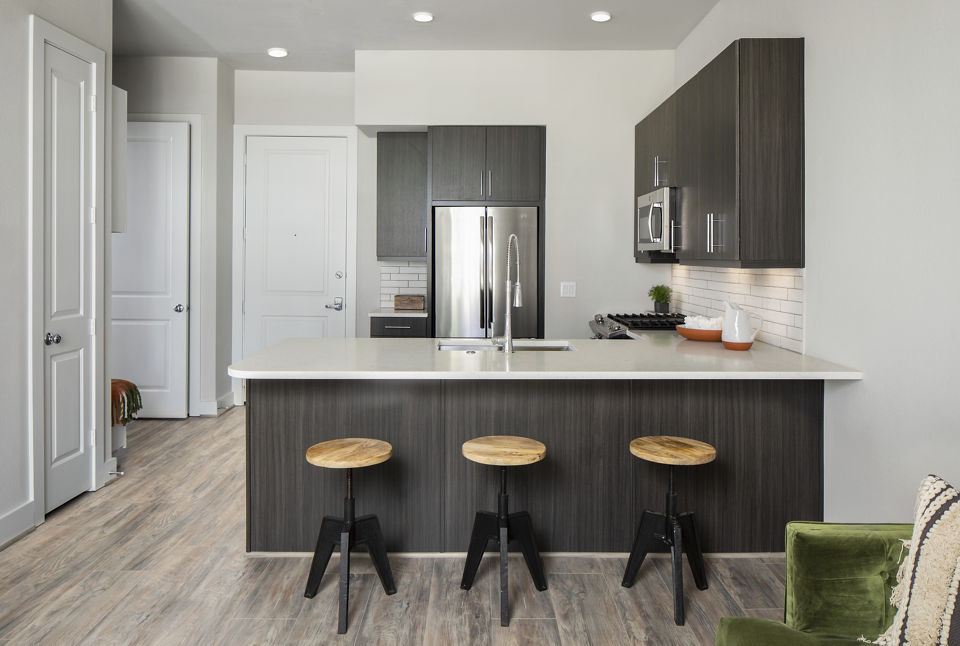 Modern kitchen with sleek cabinetry and stainless steel appliances at Broadstone Sawyer Yards Apartments