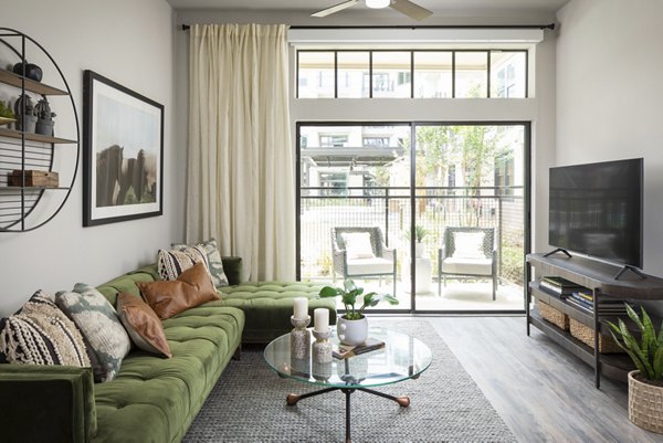 Modern living room with sleek furniture and art at Broadstone Sawyer Yards Apartments