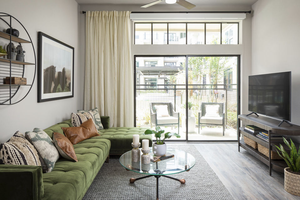 Modern living room with sleek furniture and art at Broadstone Sawyer Yards Apartments