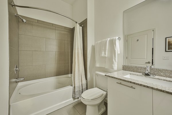 Bathroom featuring modern fixtures and marble countertops at Broadstone Toscano Apartments