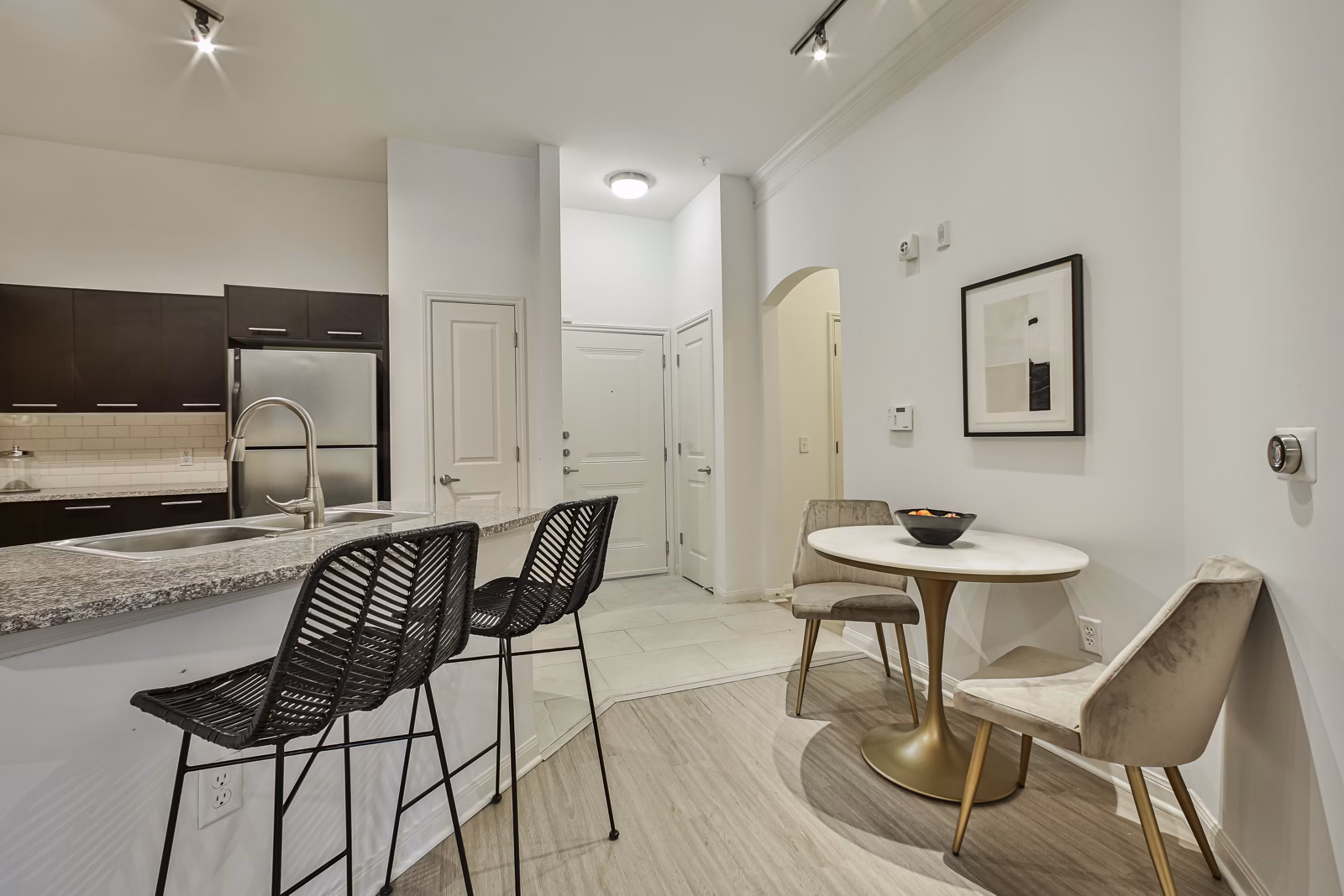 Dining area with elegant wooden table and modern chairs at Broadstone Toscano Apartments, luxury living space in Houston