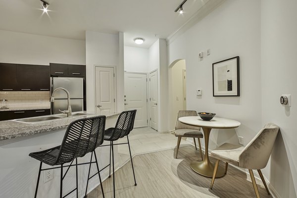 Dining area with elegant wooden table and modern chairs at Broadstone Toscano Apartments, luxury living space in Houston