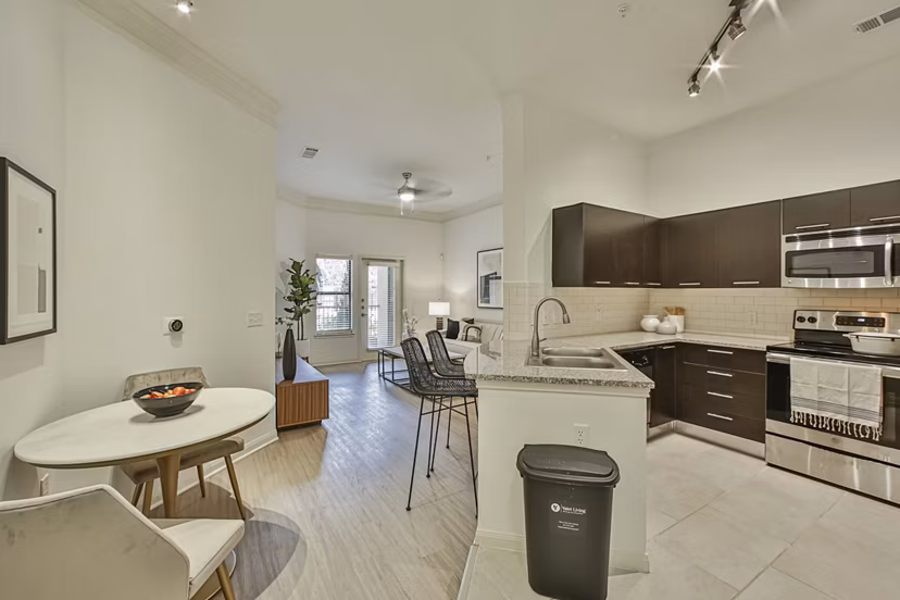 Stylish modern kitchen with granite countertops and stainless steel appliances at Broadstone Toscano Apartments