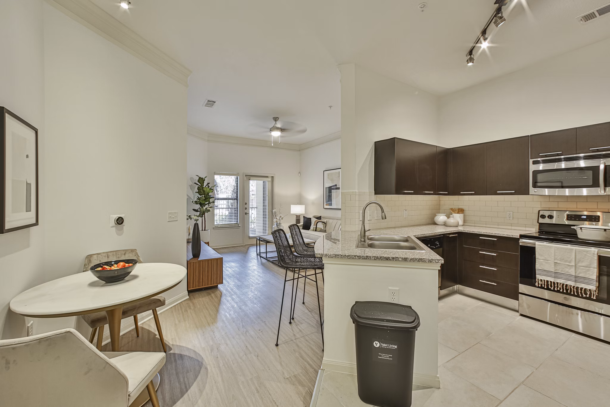 Stylish modern kitchen with granite countertops and stainless steel appliances at Broadstone Toscano Apartments