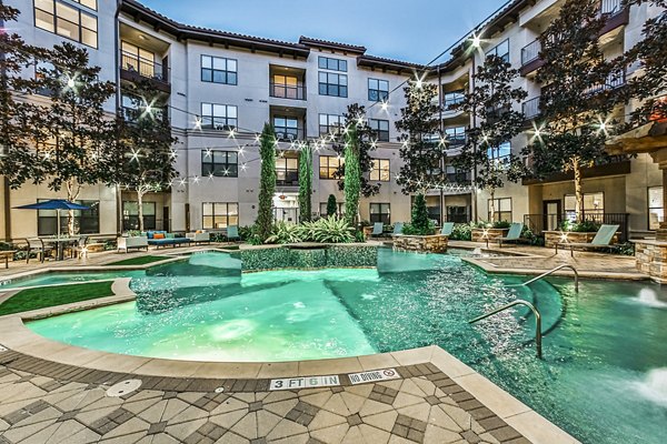 Outdoor pool surrounded by lush greenery at Broadstone Toscano Apartments, offering luxury relaxation and leisure