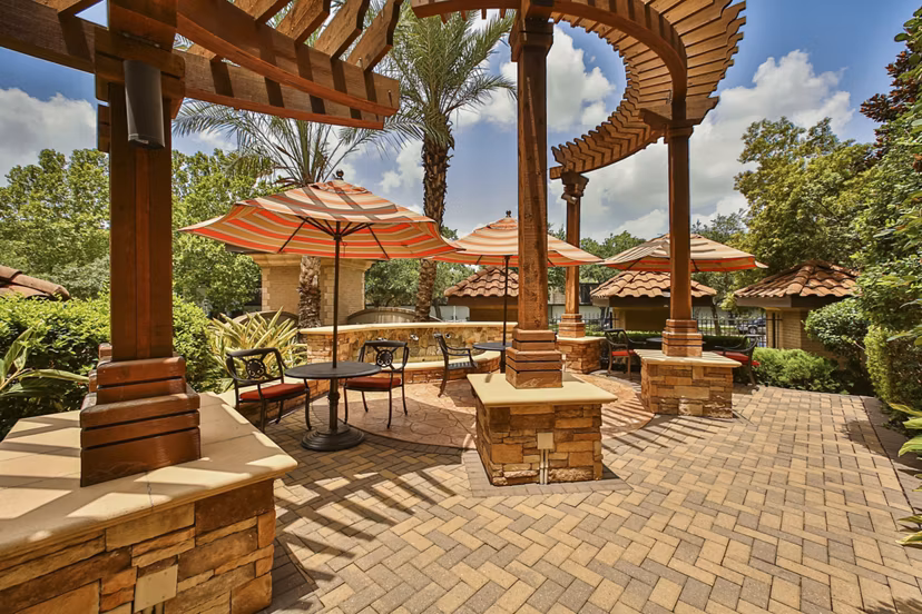 Courtyard featuring lush gardens and seating areas at Broadstone Toscano Apartments