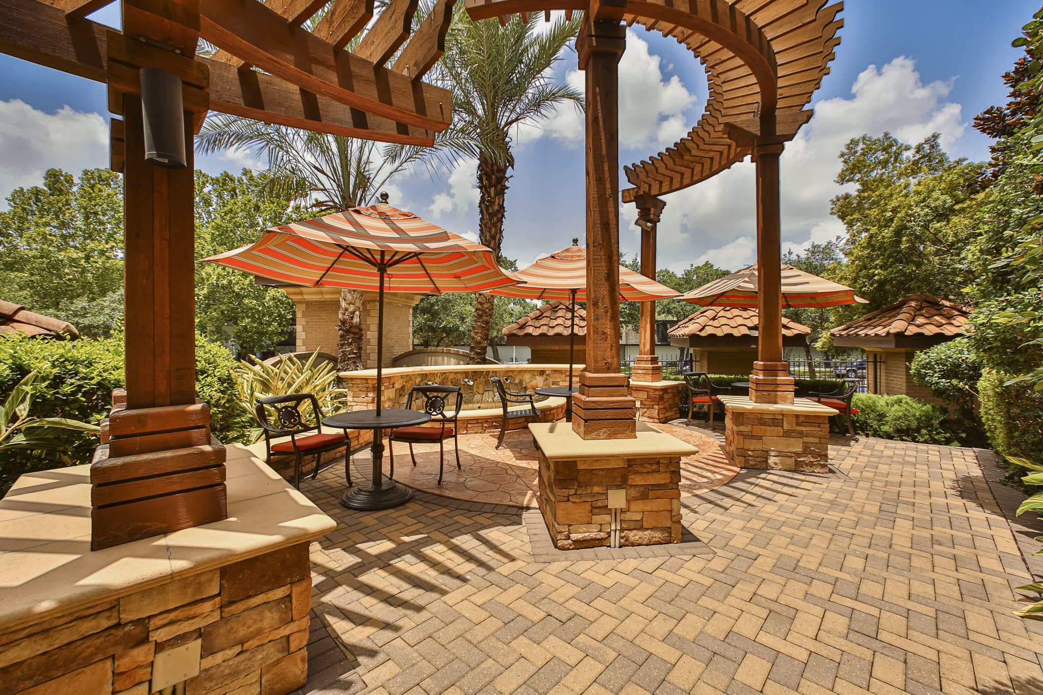 Courtyard featuring lush gardens and seating areas at Broadstone Toscano Apartments
