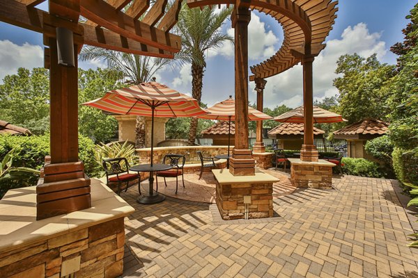 Courtyard featuring lush gardens and seating areas at Broadstone Toscano Apartments