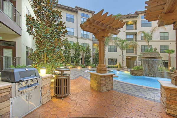 Outdoor grill area with modern seating at Broadstone Toscano Apartments, perfect for social gatherings and dining al fresco