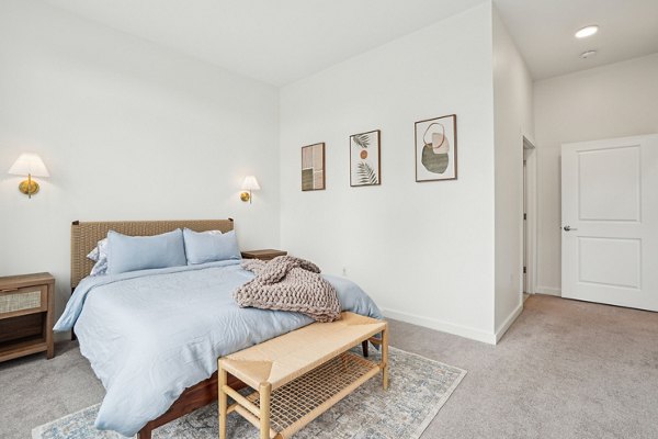 Cozy bedroom with modern furnishings at The Cove Apartments