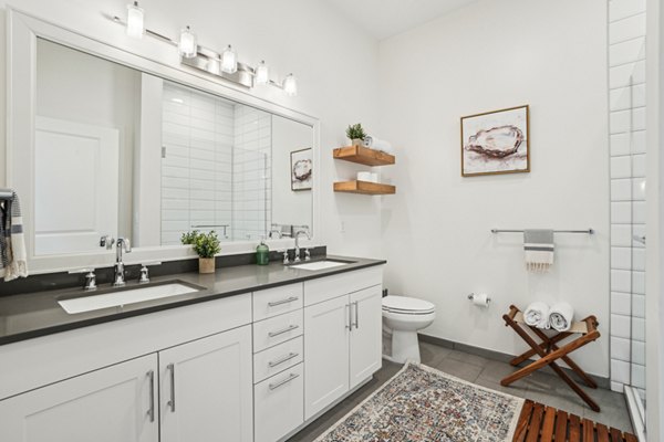 Modern bathroom featuring sleek fixtures and spacious design at The Cove Apartments