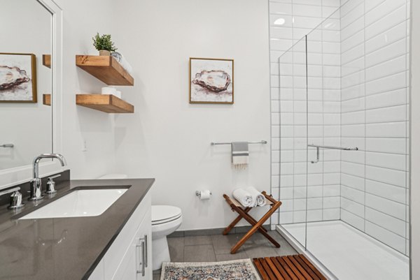 Modern bathroom featuring sleek fixtures and marble countertops at The Cove Apartments, delivering luxury living essentials