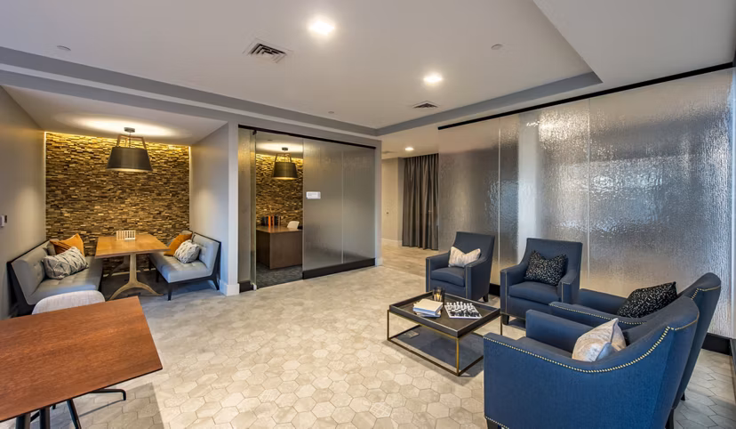 Modern lounge area with comfortable seating and a decorative wall in luxury apartments