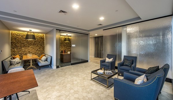 Modern lounge area with comfortable seating and a decorative wall in luxury apartments