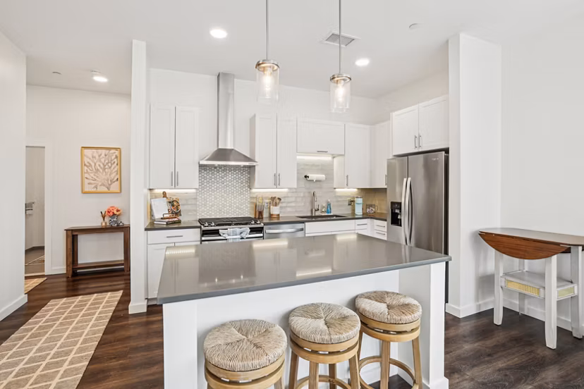 Modern kitchen with stainless steel appliances at The Cove Apartments, luxury rentals in vibrant cityscape