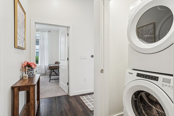 Laundry room featuring energy-efficient washers and dryers at The Cove Apartments