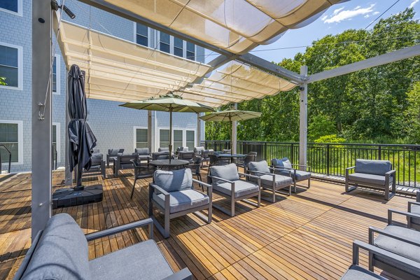 Outdoor patio space with modern furniture at The Cove Apartments, offering a relaxing environment for residents to enjoy the fresh air