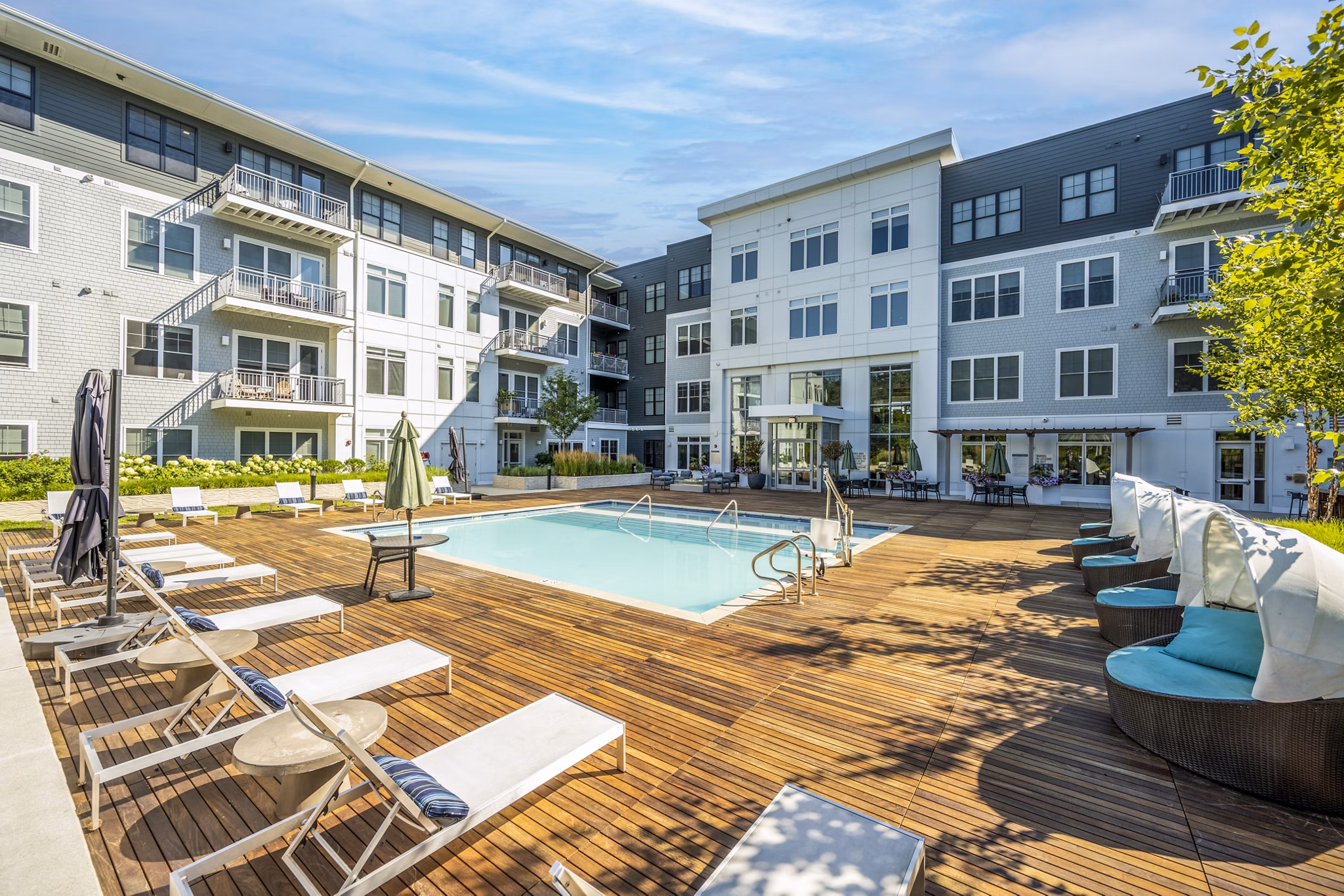 Scenic outdoor pool at The Cove Apartments, offering luxury amenities in a tranquil setting