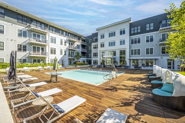 Scenic outdoor pool at The Cove Apartments, offering luxury amenities in a tranquil setting