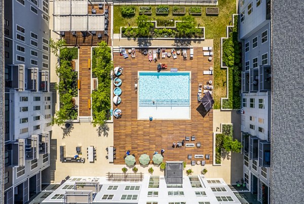 Relaxing pool area with lounge chairs at The Cove Apartments, luxury apartments by Greystar