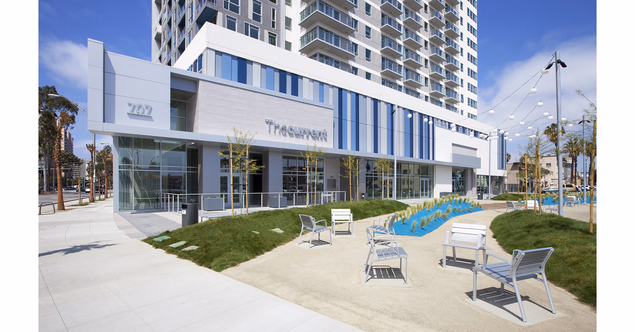 Brand signage at The Current Apartments showcasing luxury living in vibrant urban location